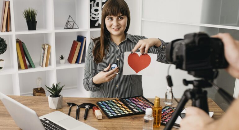 female-make-up-blogger-with-streaming-with-camera-laptop-home