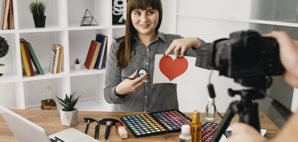 female-make-up-blogger-with-streaming-with-camera-laptop-home